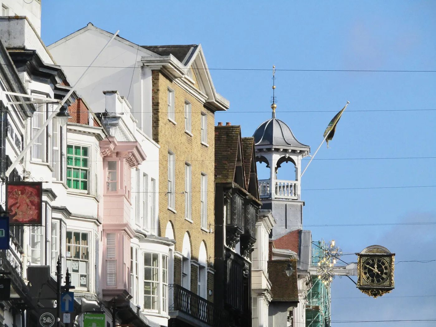 Painted period frontages on Guildford High Street below the Guildhall clock