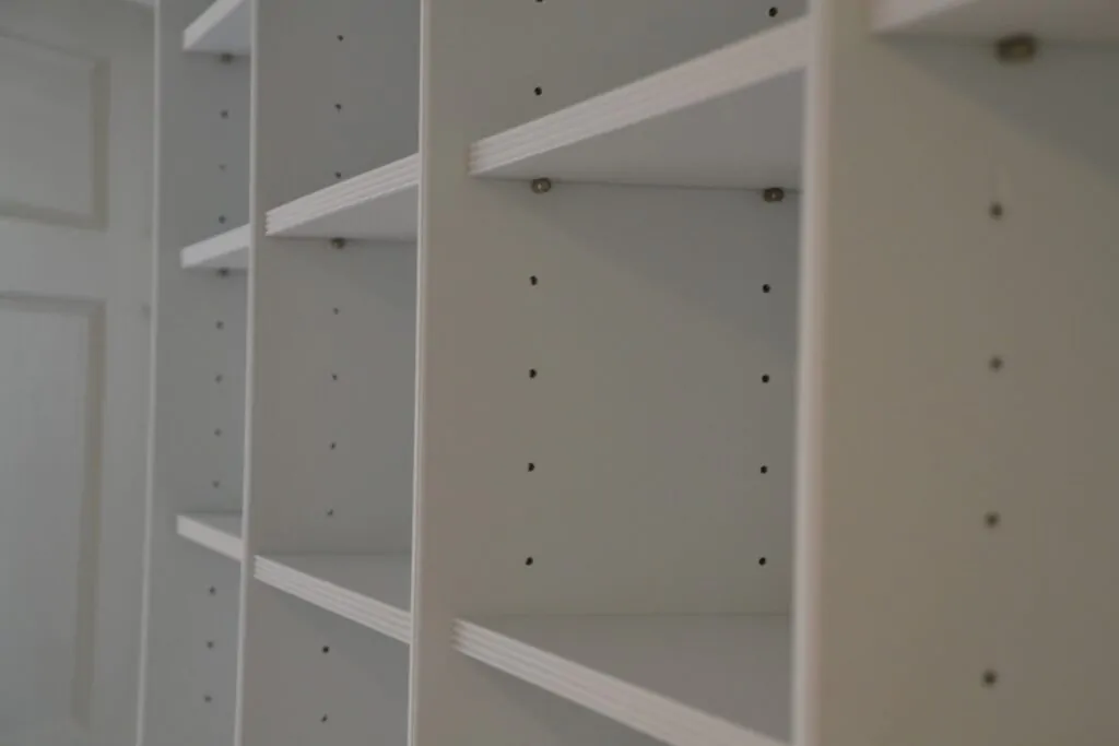 Close-up of empty white adjustable shelves