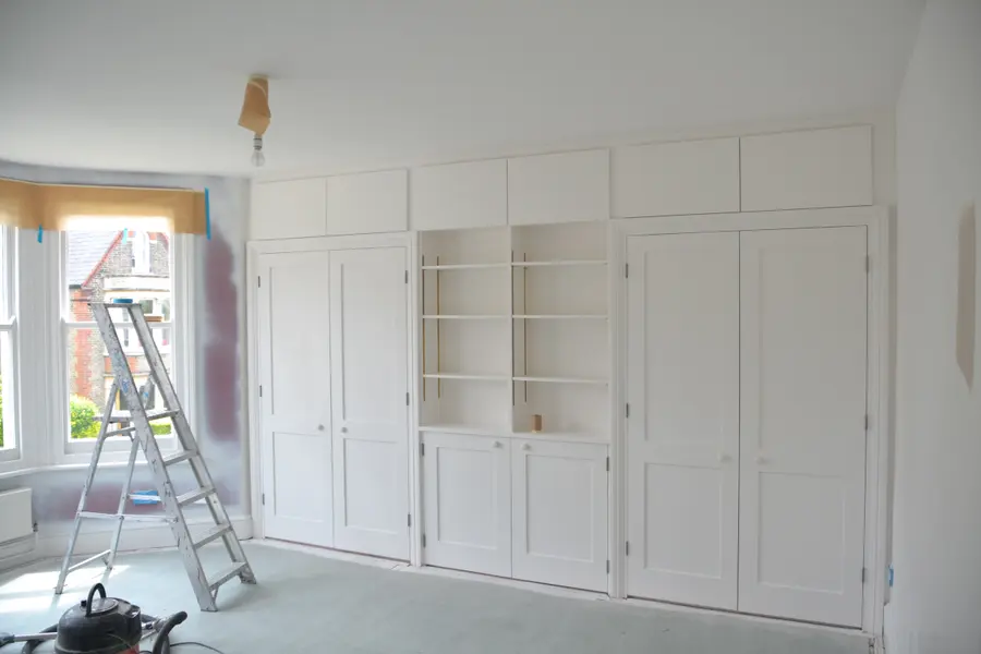 Built-in cabinetry repainted in a clean white finish