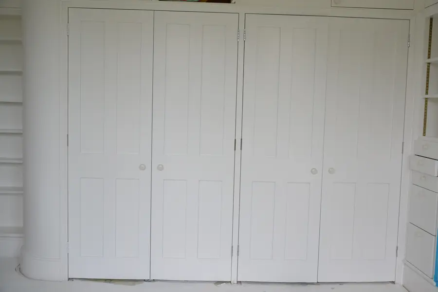 Panelled cabinet doors hand-finished in white