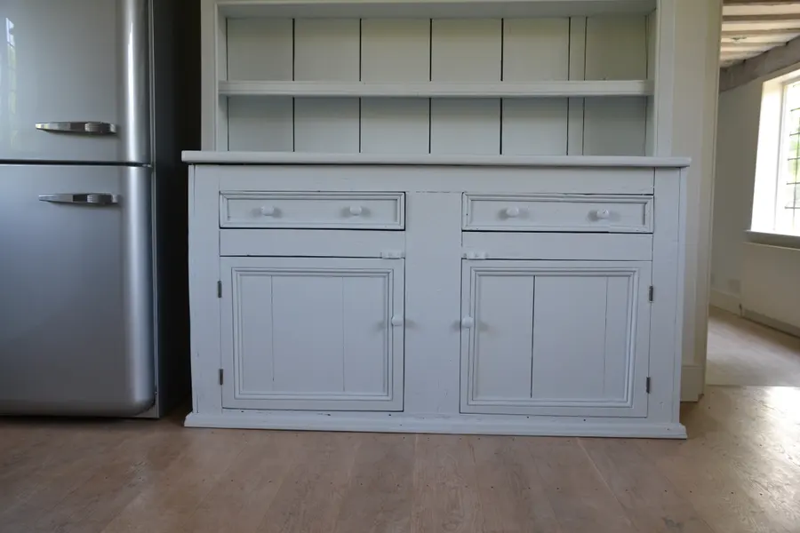 Welsh dresser repainted in soft grey in a cottage kitchen