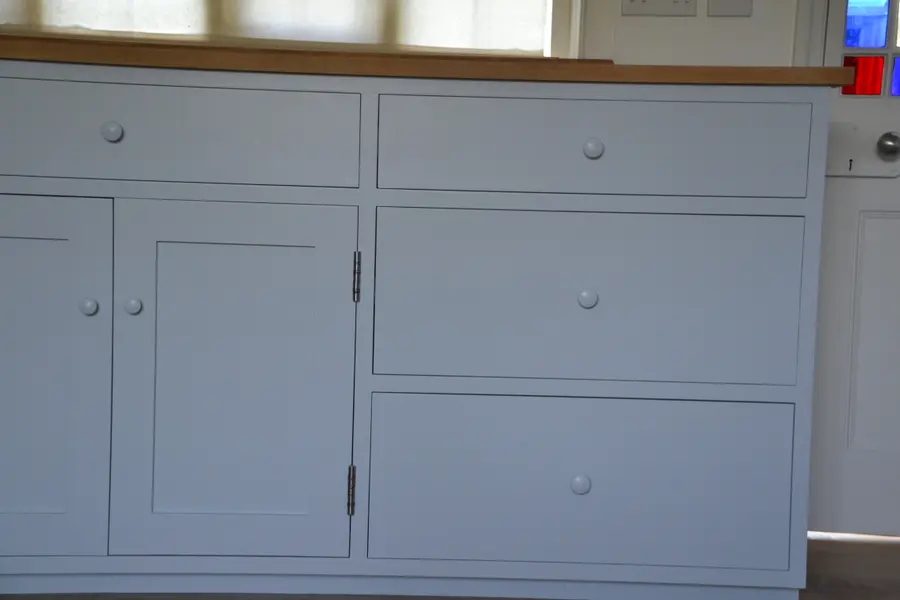 Hand-painted kitchen drawers and cupboards in pale grey