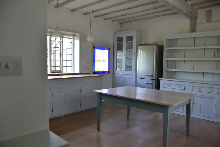 Cottage kitchen with hand-painted dressers, cupboards and table