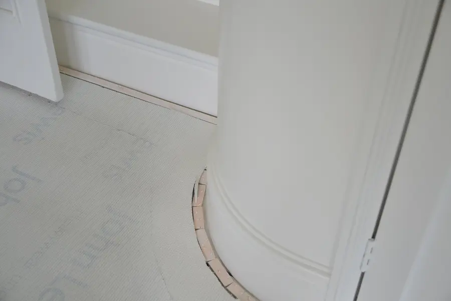 Repainted curved column with floors protected by dust sheets