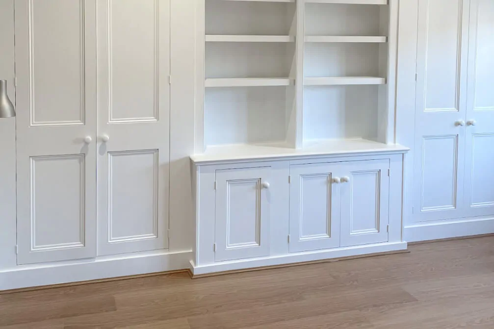 White built-in cabinetry with open shelves and closed cupboards