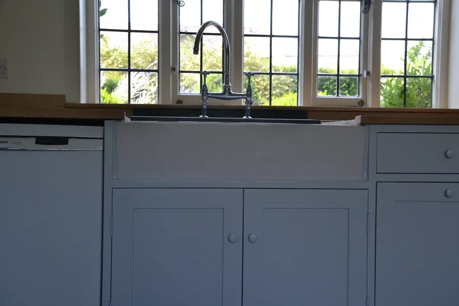 Painted kitchen cabinetry with a timber worktop