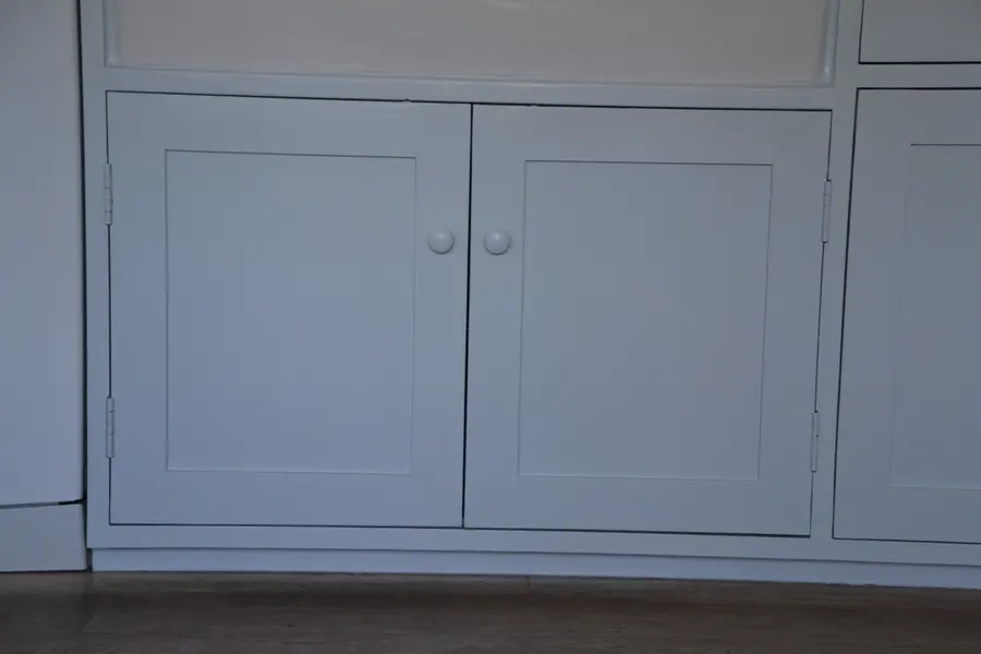 Run of sprayed cupboard doors and drawers in a country kitchen