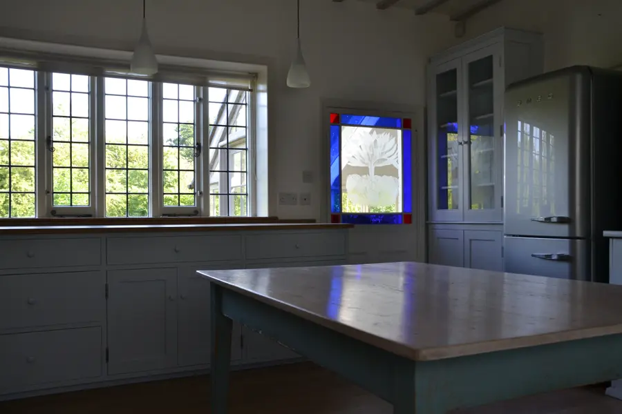Country kitchen with resprayed units, dresser and island table