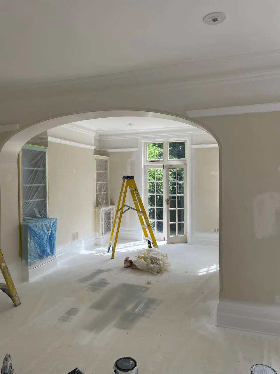 Built-in shelving being painted during an interior decorating project