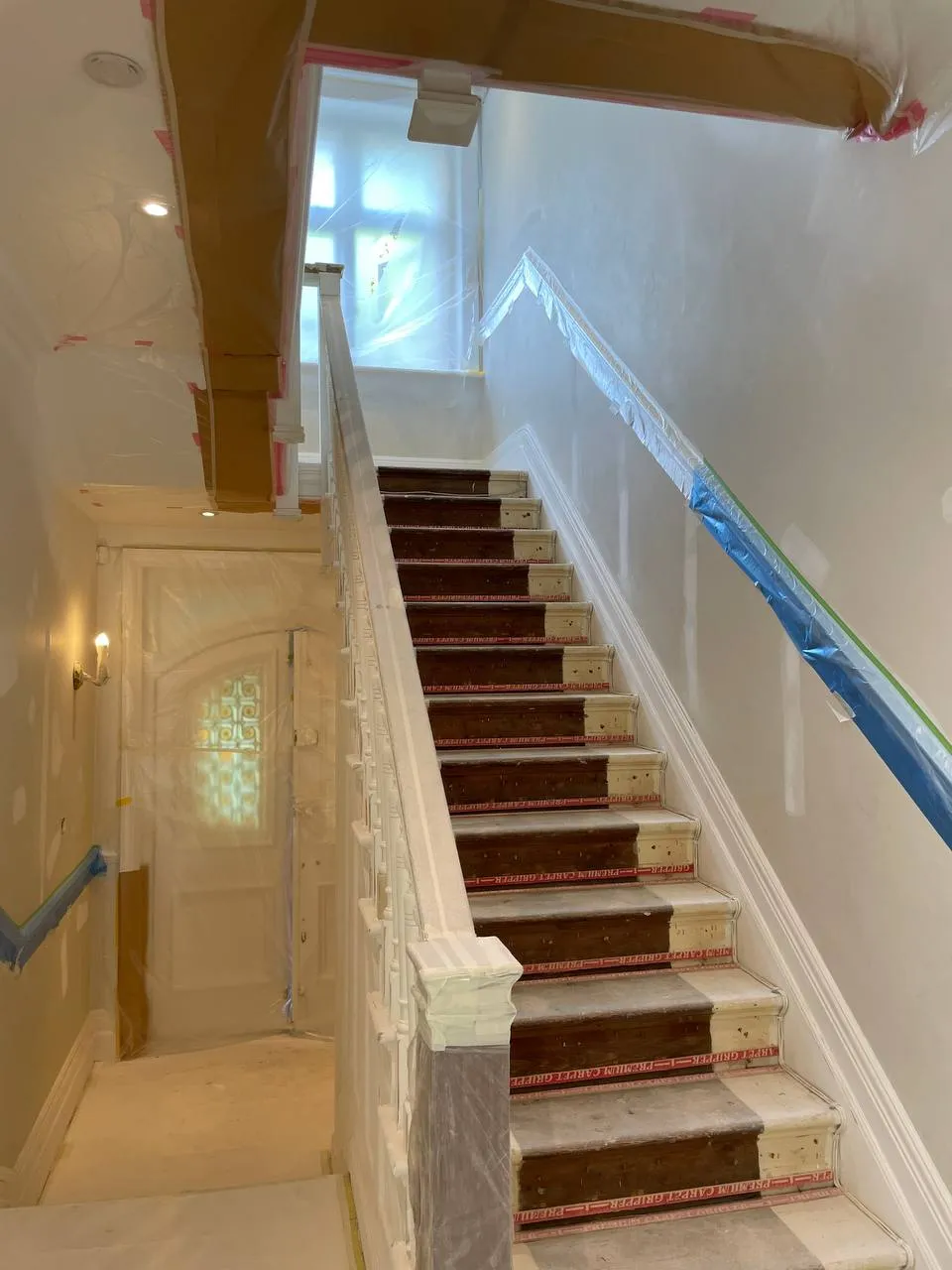Panelled staircase wall repainted in a period home