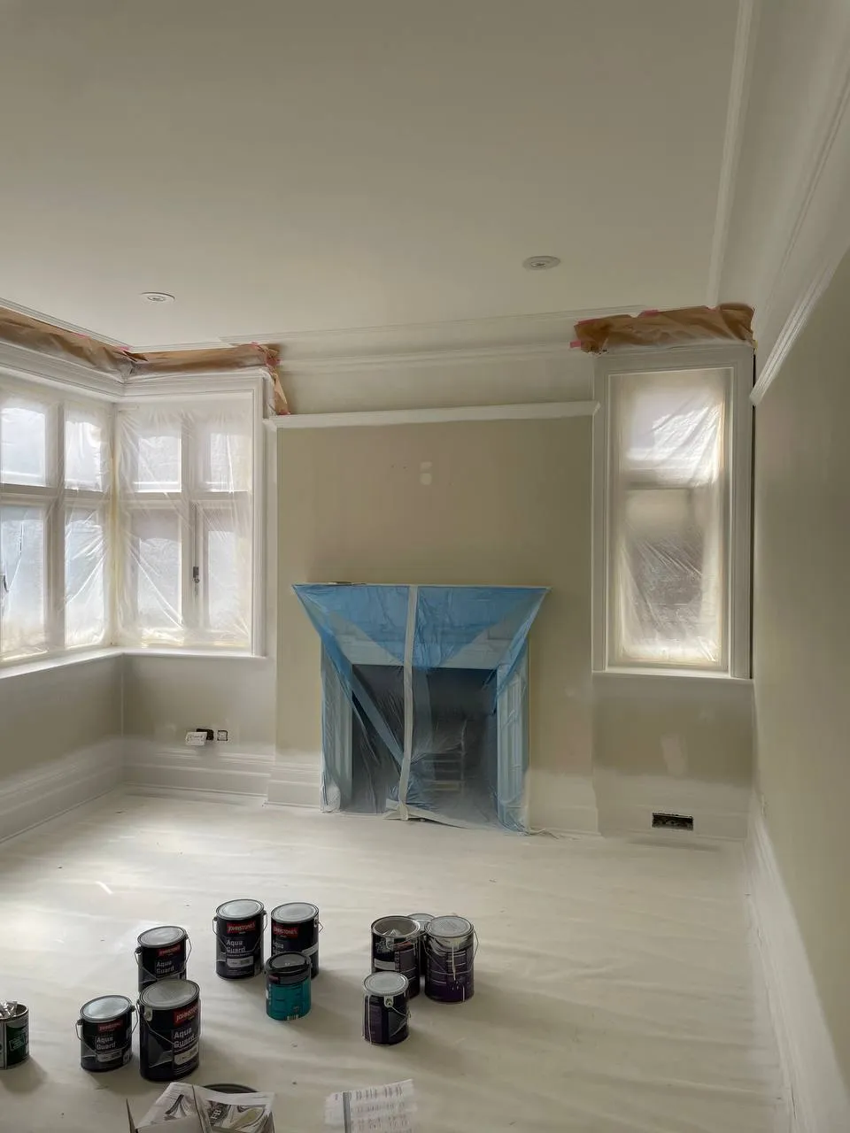 Reception room being repainted in a neutral tone between tenancies